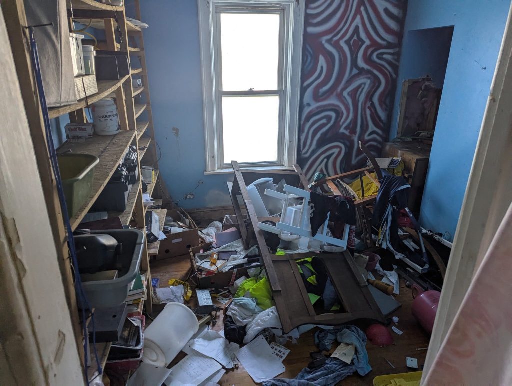 Room filled with loose household contents before cleanout