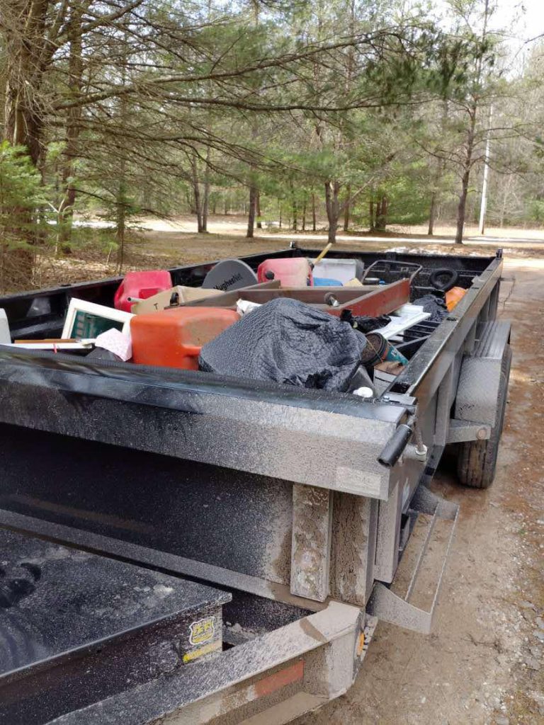 Furniture and household items loaded in a Big Dogg dump trailer